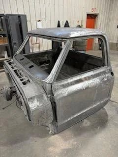 Truck cab blasted to bare metal