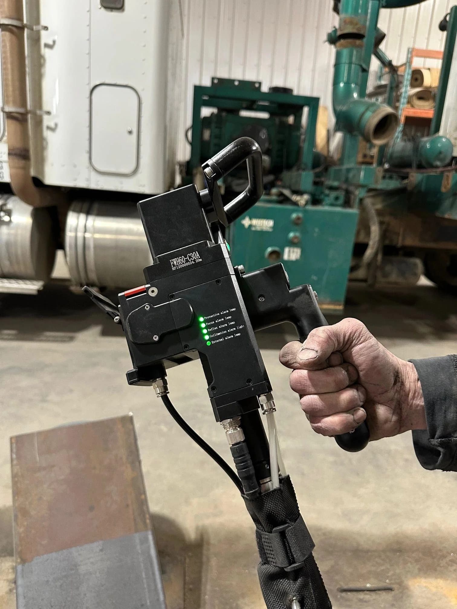 Operator running a handheld laser cleaner