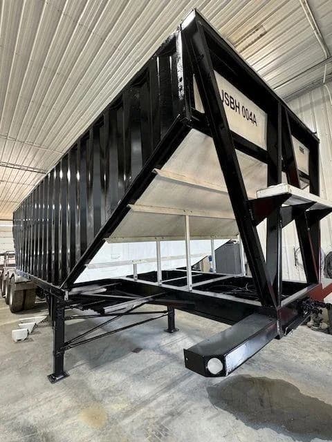 Restored black grain trailer, side view